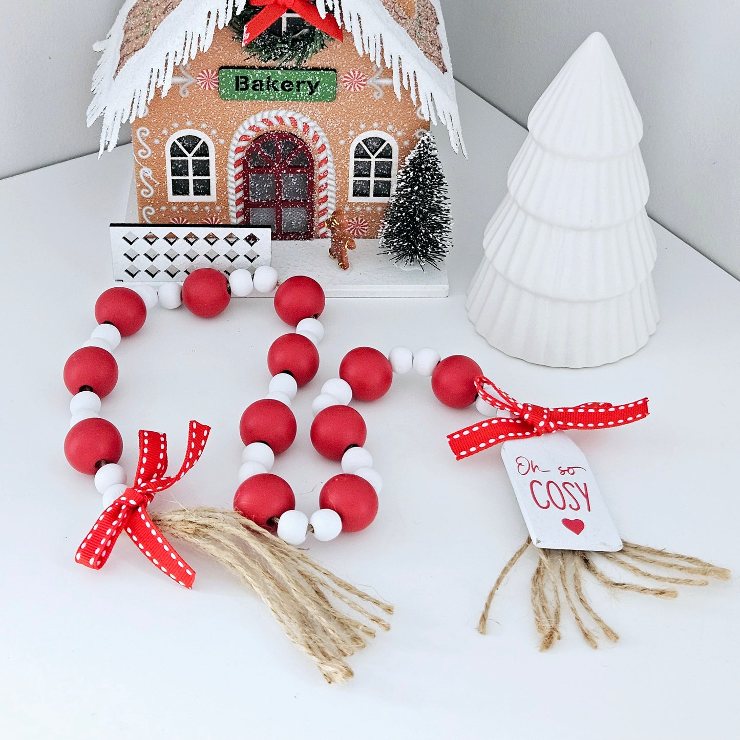 red and white beaded garland with oh so cosy christmas tag and red bow