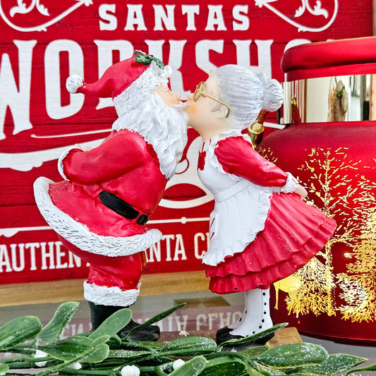 santa and mrs claus kissing ornament in red and white