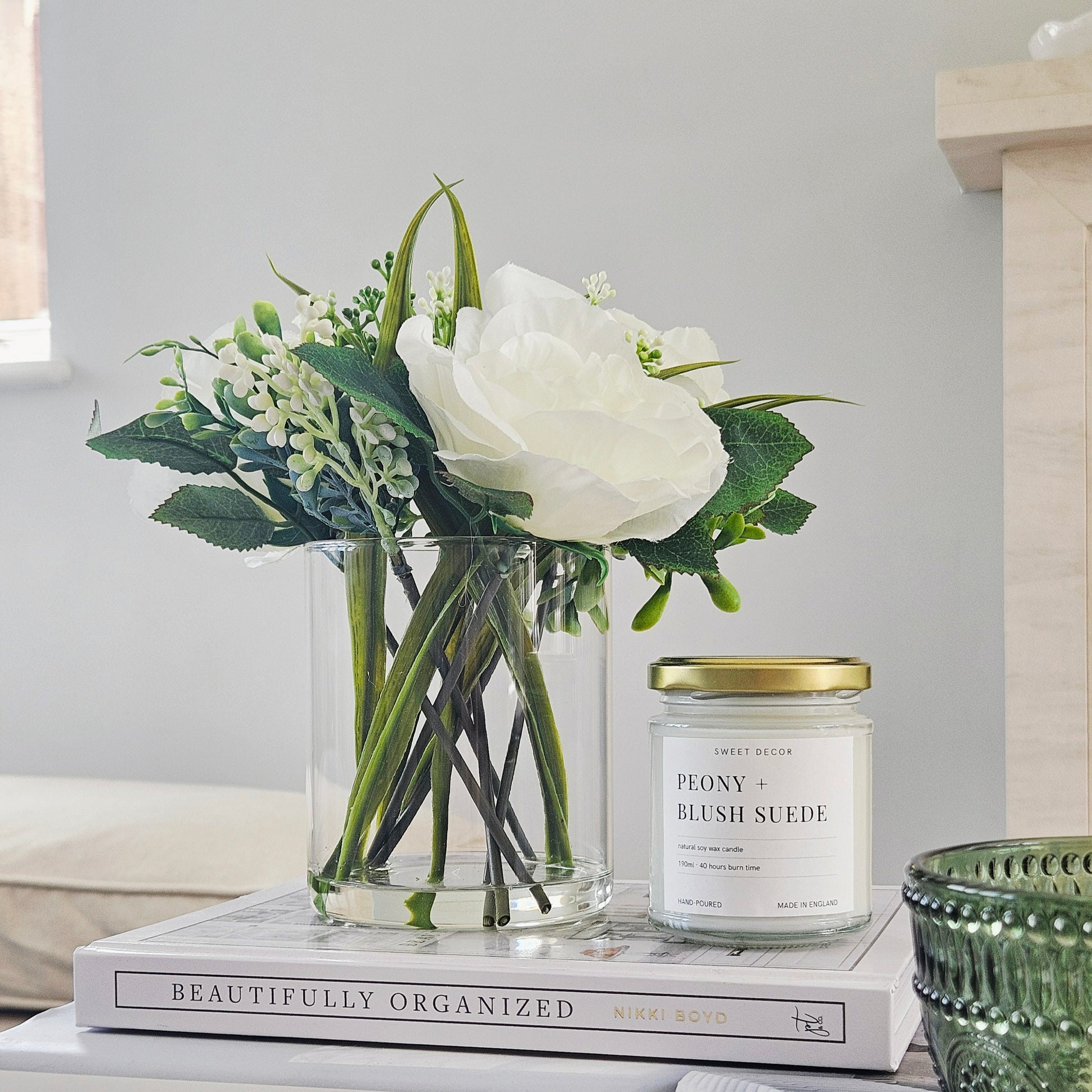 artificial roses in a glass pot by candlelight home