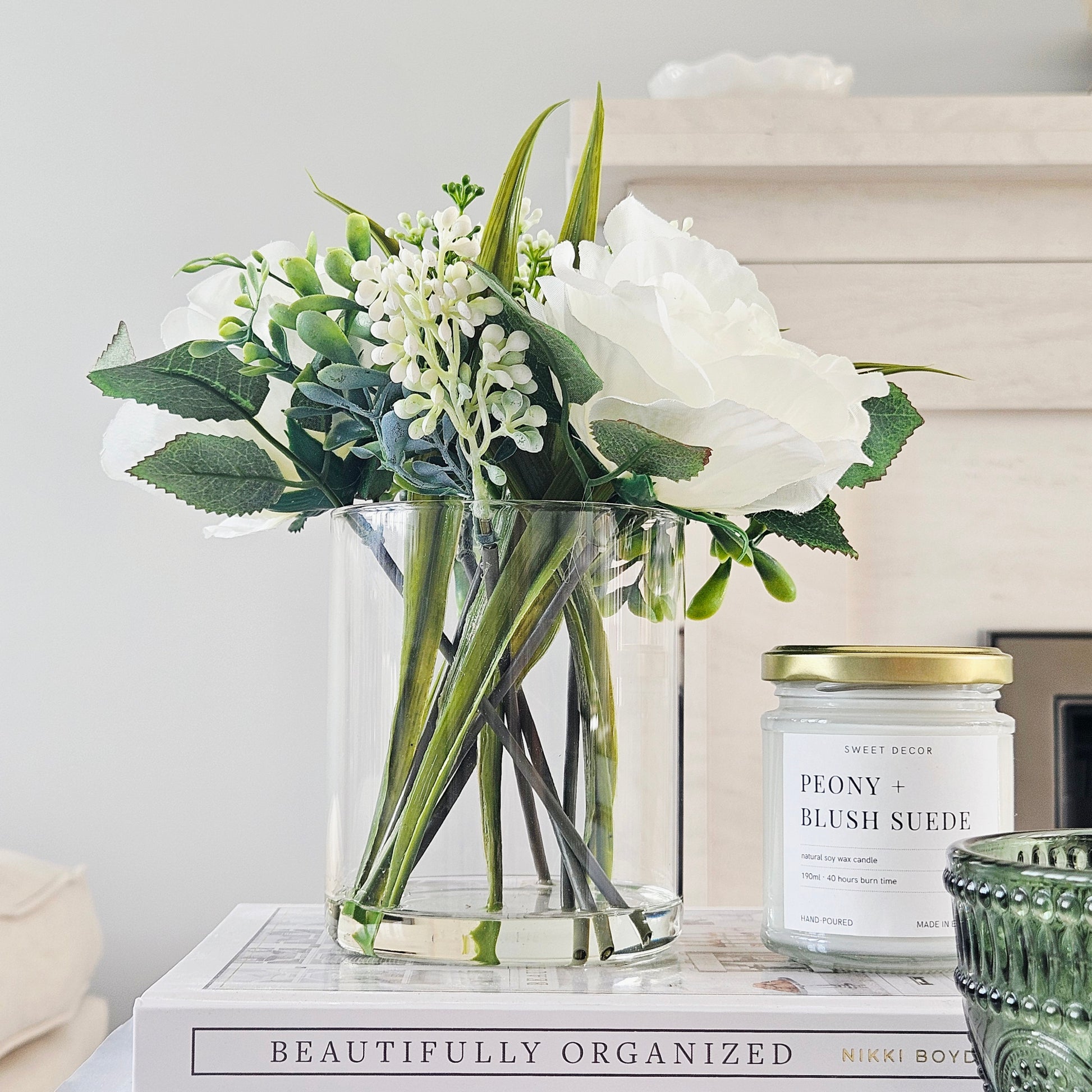 artificial roses in a glass pot by candlelight home
