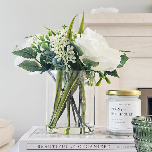 artificial roses in a glass pot by candlelight home
