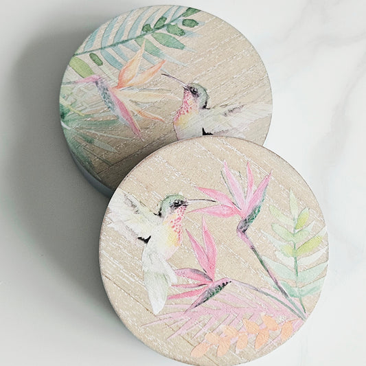 Two round chunky hummingbird coasters with bird and leaf designs 