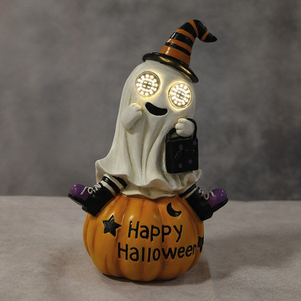 A Halloween-themed figurine of a ghost sitting on a pumpkin, with a witch hat, glowing eyes, and 'Happy Halloween' written on the pumpkin. LED ghost pumpkin Halloween decoration