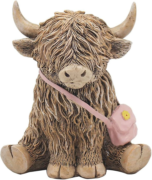 highland cow ornament wearing a pink handbag with yellow flower