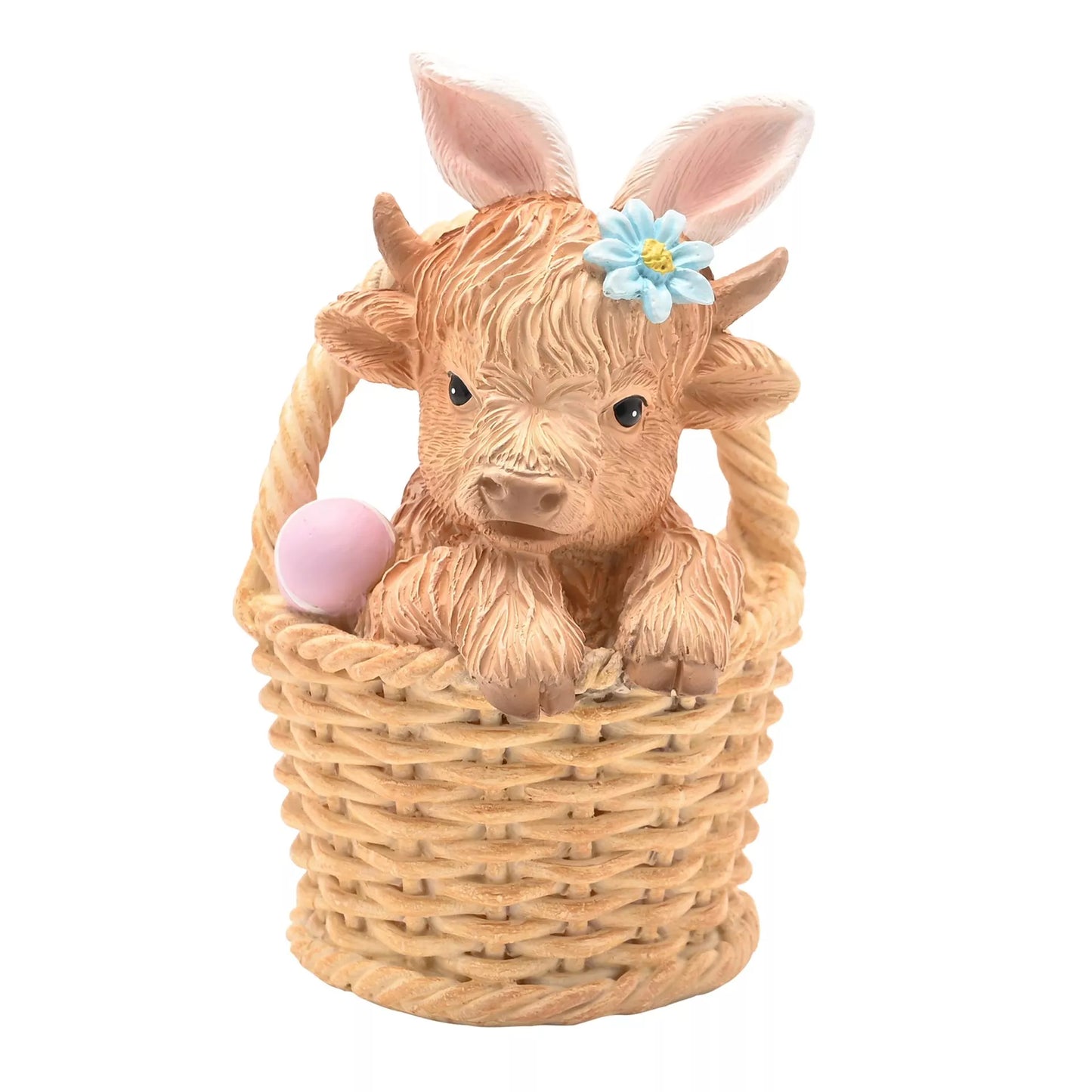 Decorative figurine of a Highland cow with a flower in its hair inside a wicker basket 
