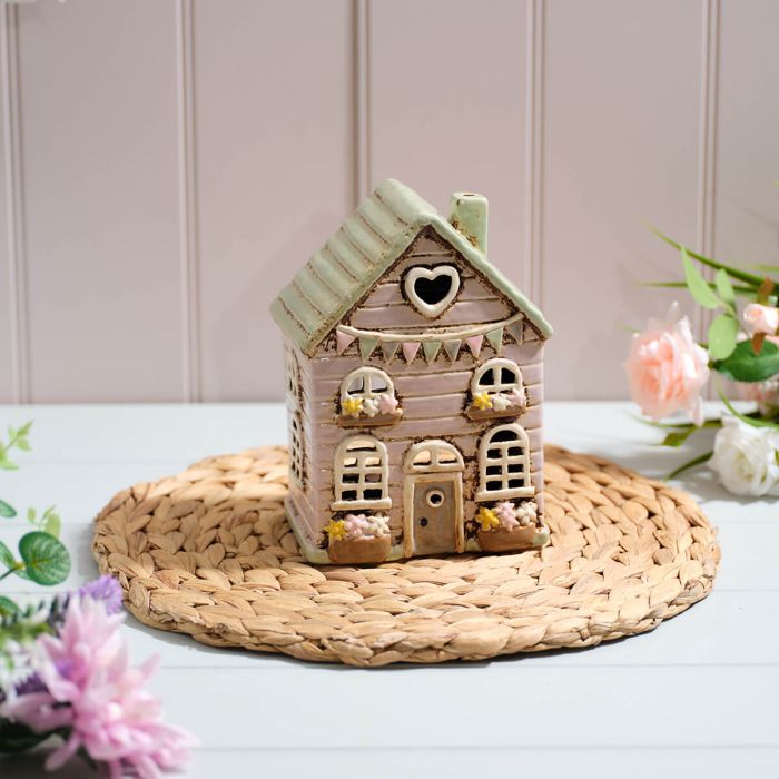 cottage garden stoneware tea light holder with bunting and flower baskets