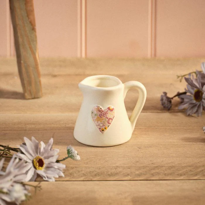 Ditsy Floral Stoneware Embossed Heart Milk Jug with a delicate floral pattern for farmhouse and cottage-style kitchens.