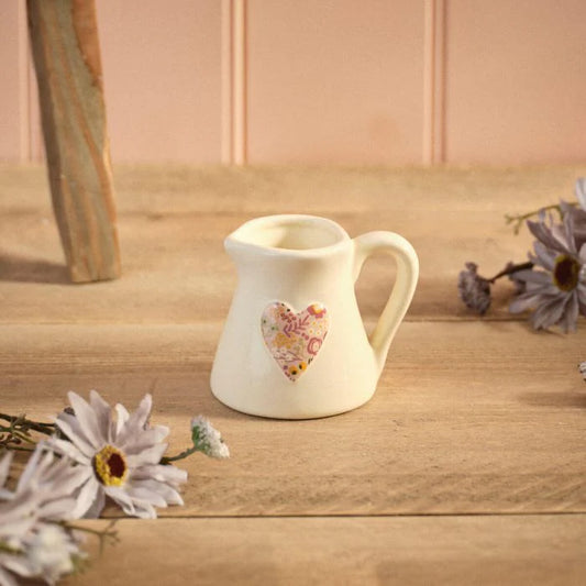 Ditsy Floral Stoneware Embossed Heart Milk Jug with a delicate floral pattern for farmhouse and cottage-style kitchens.