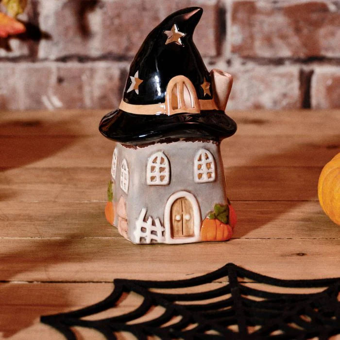 Haunted Hat Ceramic House Tea Light Holder for Halloween home décor with an illuminated spooky house design.