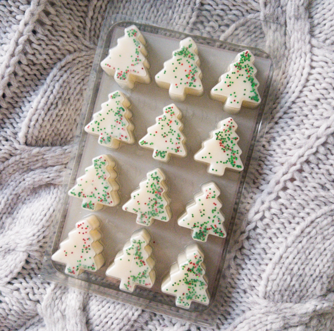 Christmas tree-shaped wax melts with glitter on a tray 