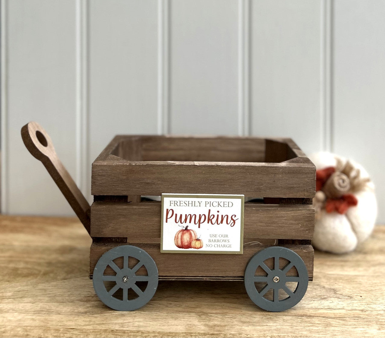 a wooden cart with handle and wheels freshly picked pumpkins sign