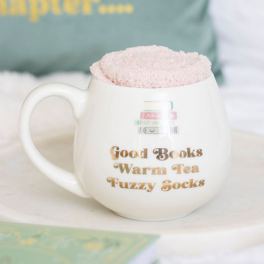 Good books mug with pink fluffy socks inside