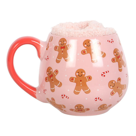 pink gingerbread mug with candy canes and pink fluffy socks inside 