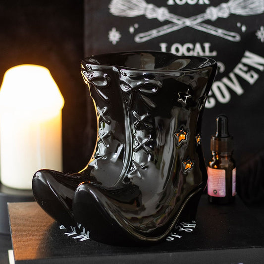 Black ceramic witches boot-shaped oil burner with star patterns on 