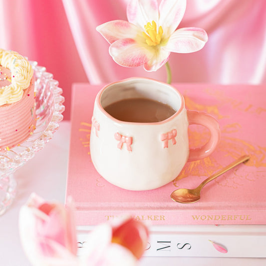 Pink mug with bow design and pink handle