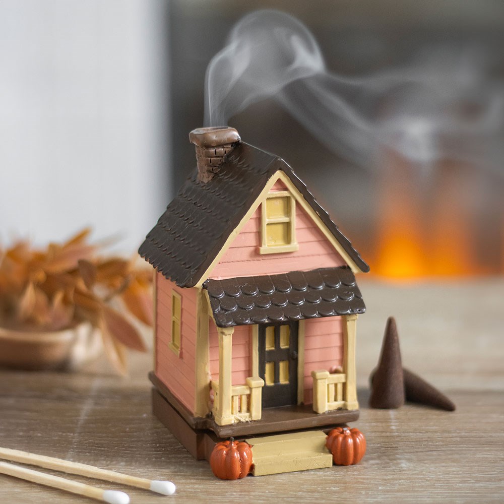 pink Small house-shaped incense burner with smoke and pumpkins 