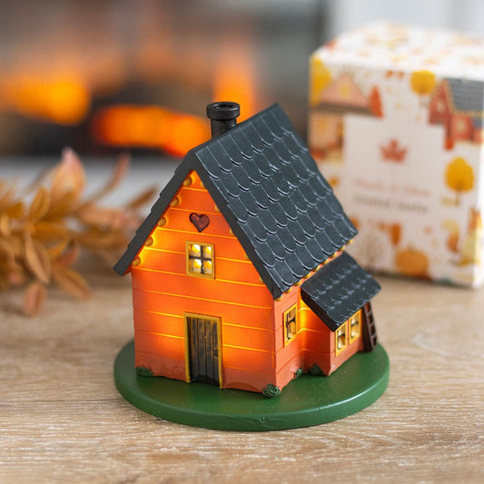 Small decorative led woodland house with a heart on the door, lit from within.