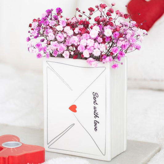 White envelope-shaped vase 'Sent with love' text, and a heart symbol. love letter design