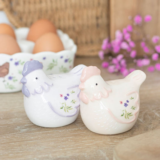 Two ceramic hen salt n pepper figurines with floral designs 