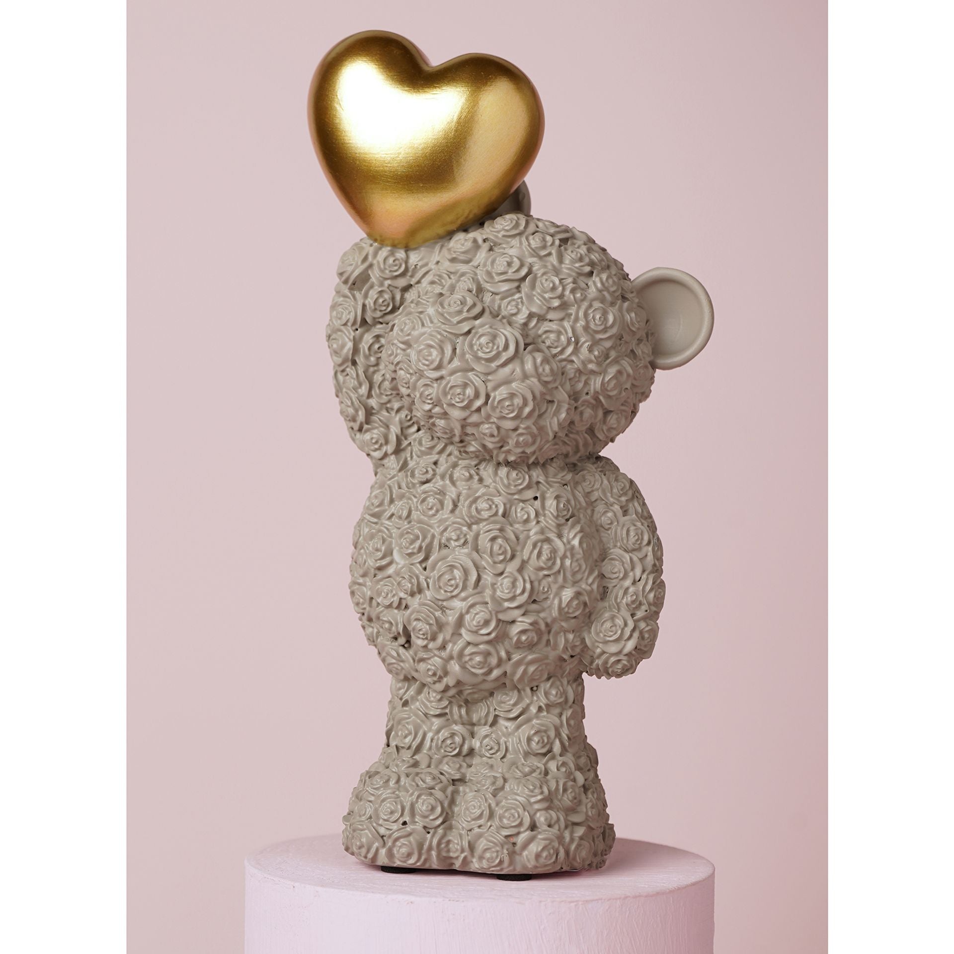 grey bear ornament holding a gold heart 