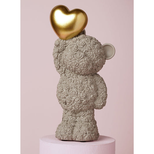 grey bear ornament holding a gold heart 