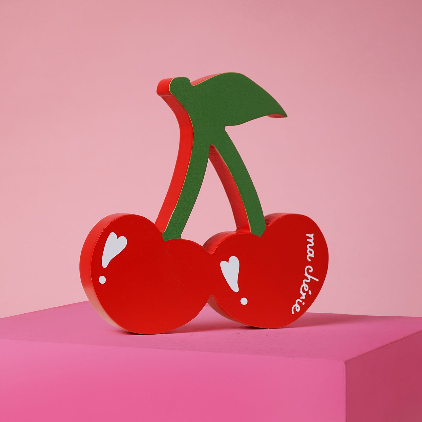 Red cherry-shaped free standing plaque with a green stem and mon cherie wording