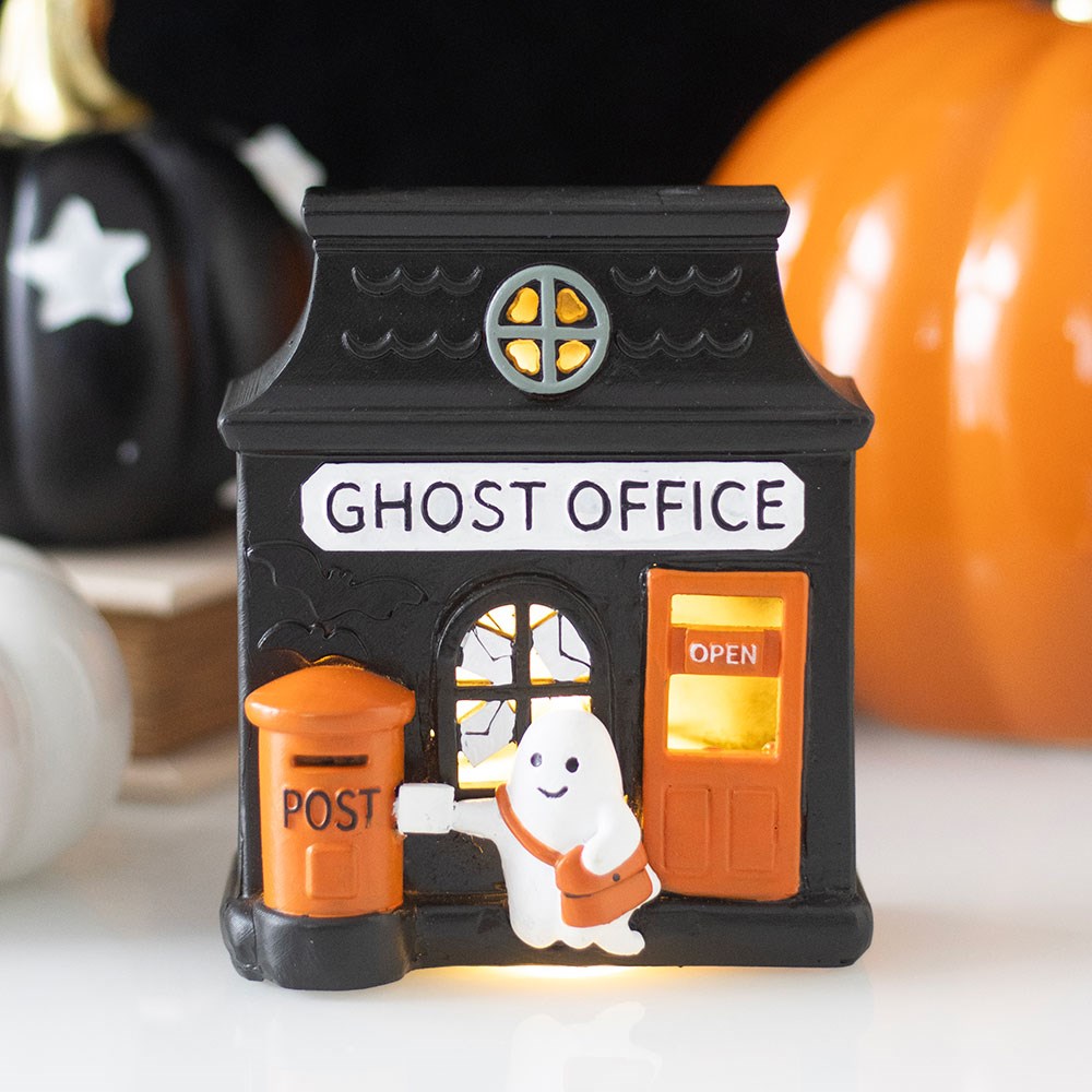 Halloween-themed miniature building with ghost and pumpkins in the background ghost office led