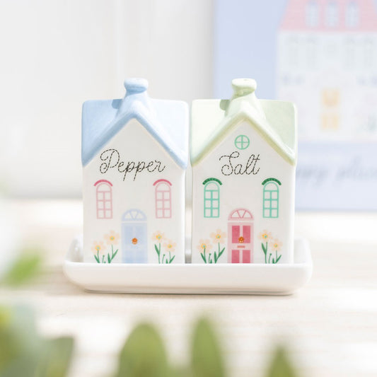 salt and pepper pastel house shakers on a white tray