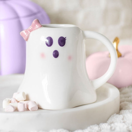 White mug shaped like a ghost with pink bow and cheeks