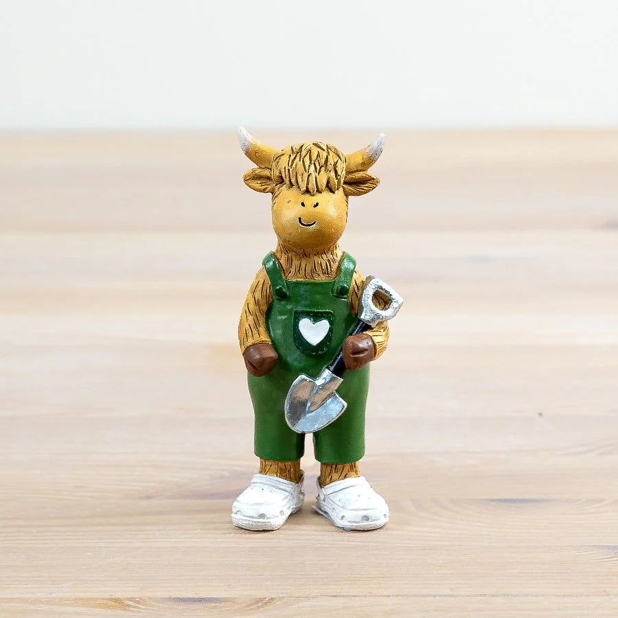 Figurine of a cow in green overalls holding a shovel 12cm