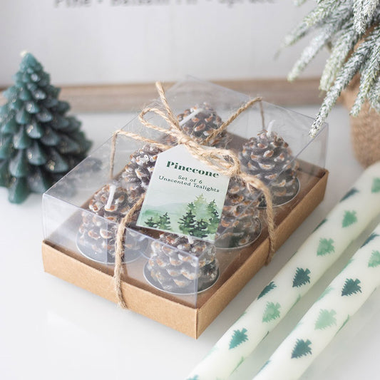 Set of 6 pinecone candles tealights in a clear box with a decorative bow