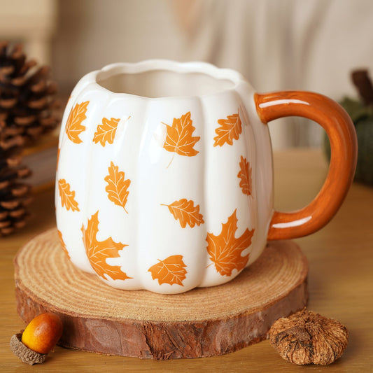 Pumpkin-shaped mug with orange leaf patterns and orange handle by country living