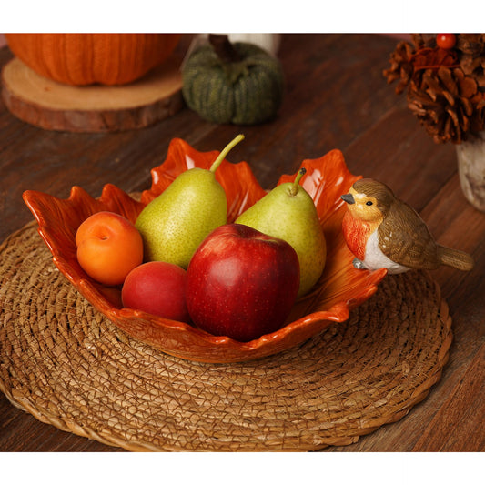 robin on a brown leaf ceramic bowl 