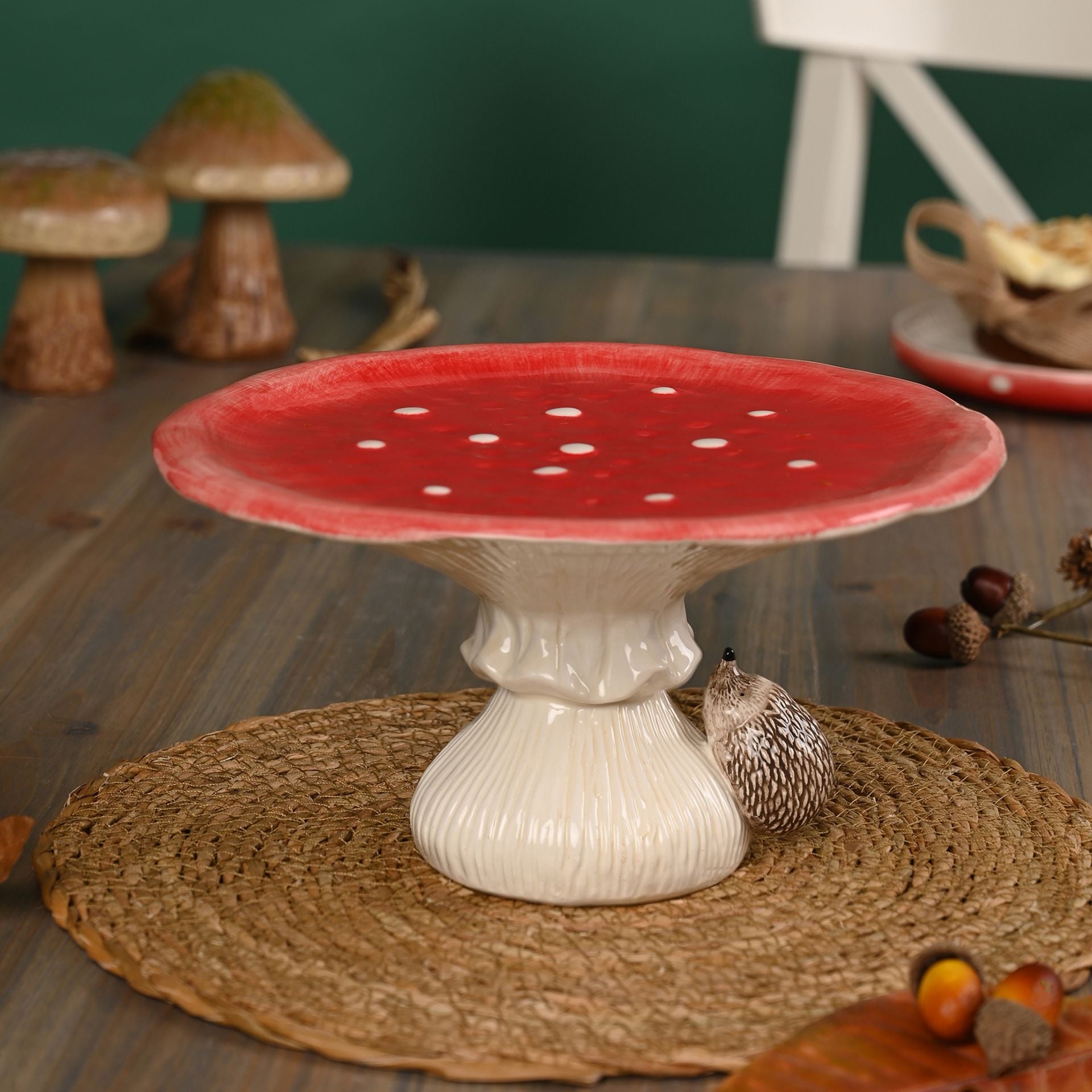 red ceramic toadstool cake stand with hedgehog on the bottom 