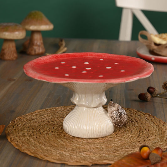 red ceramic toadstool cake stand with hedgehog on the bottom 