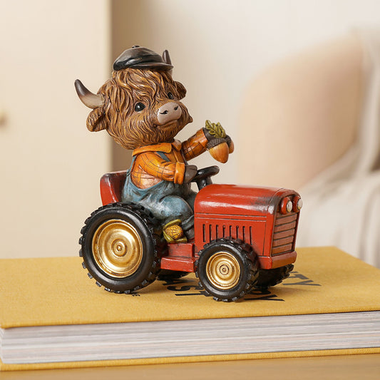 Statue of a cow driving a red tractor holding acorns