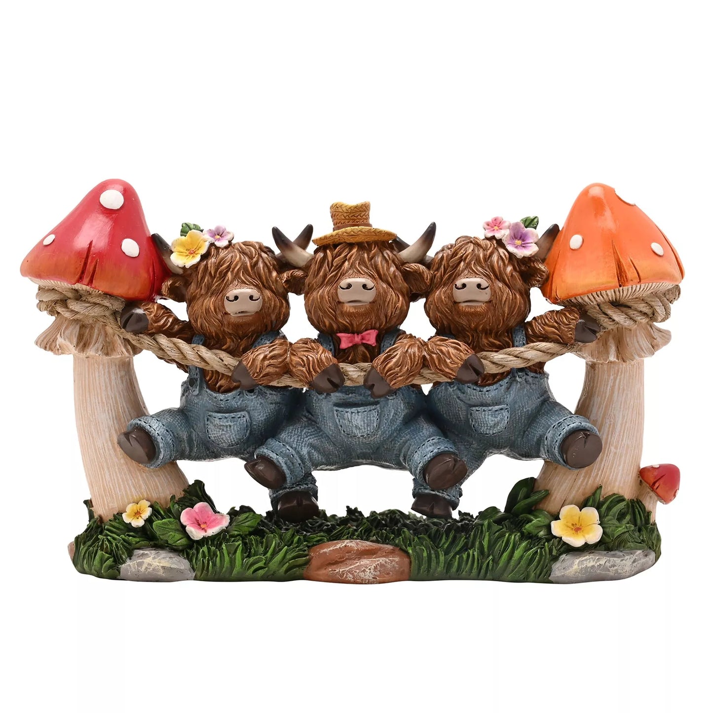 Three Highland cow figurines holding onto a top as they dangle with mushrooms and flowers 