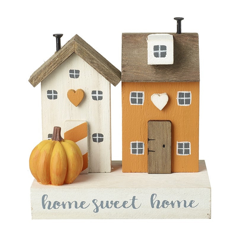 Decorative wooden houses with a pumpkin and 'home sweet home' text 