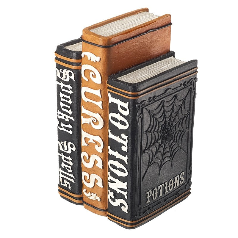 Three decorative books with titles 'Spells', 'Curses', and 'Potions' 