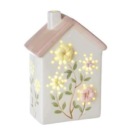 Decorative led light shaped like a house with floral designs and glowing lights 