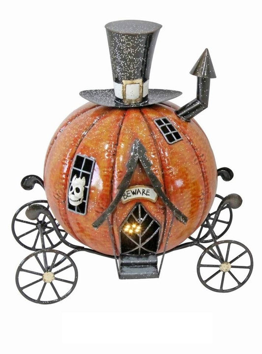 Decorative light up pumpkin with carriage wheels, top hat, and 'Beware' sign made from metal