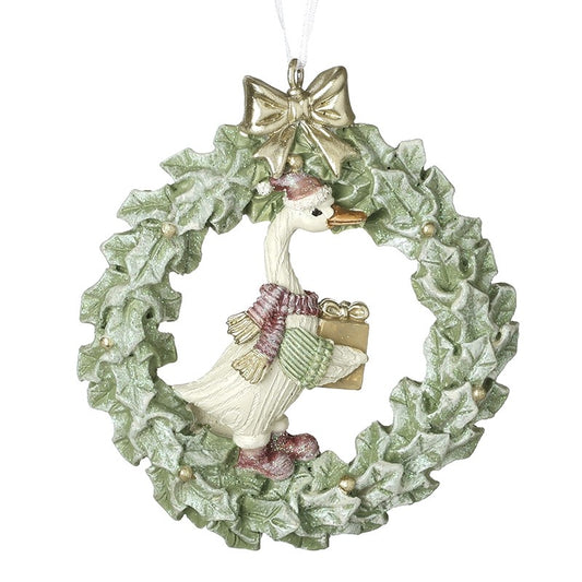 duck inside a wreath tree decoration with pink scarf holding a present