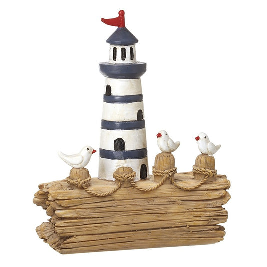 Decorative lighthouse with birds on a wooden block