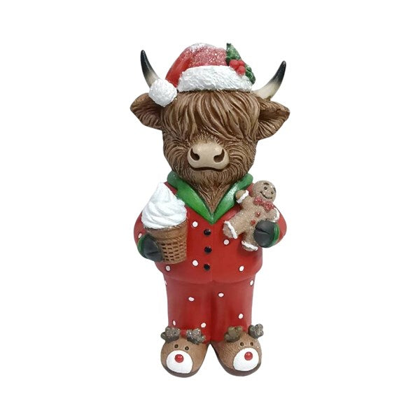 Mr Christmas Highland cow figurine wearing red Christmas pyjamas and Santa hat