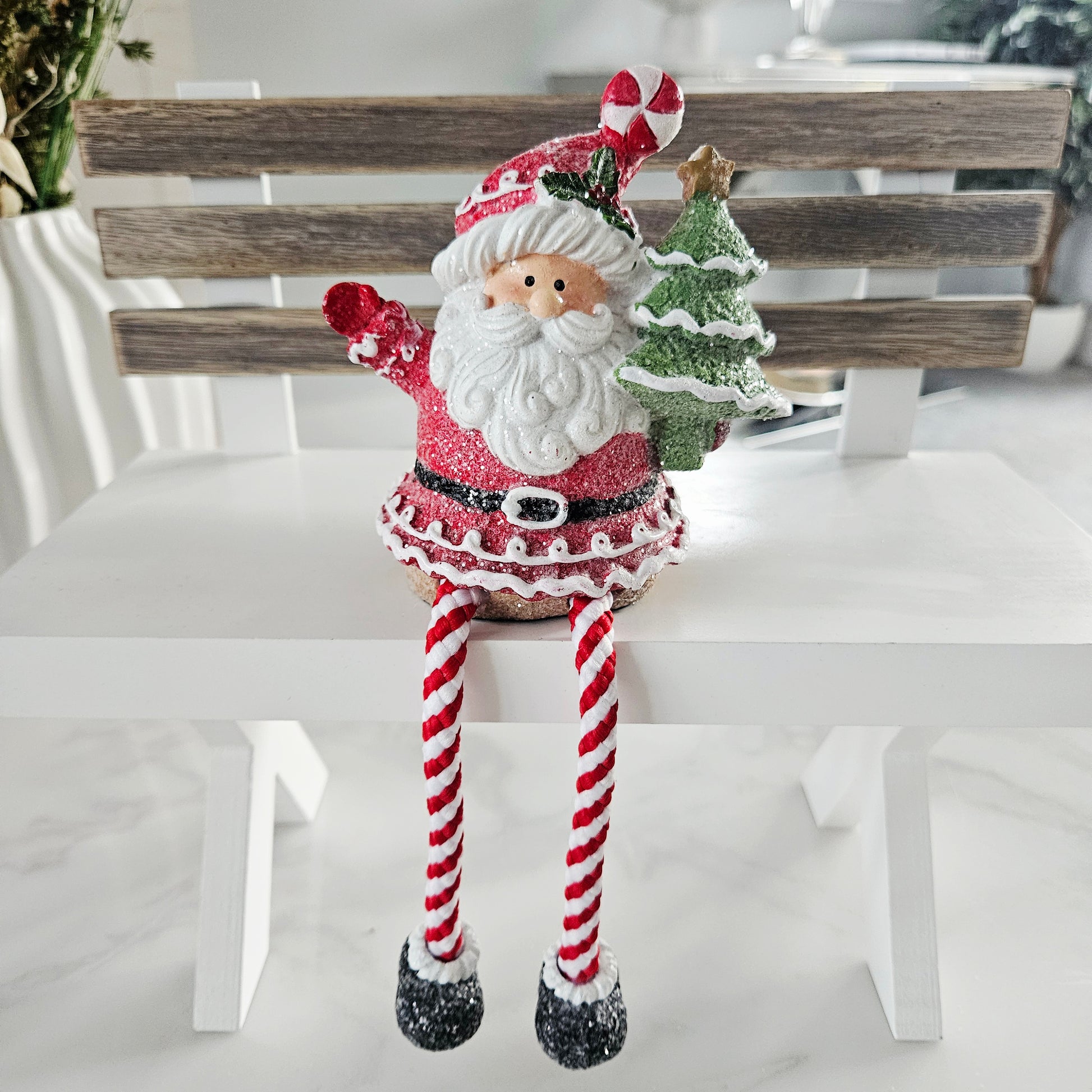 Decorative Santa Claus figure with candy cane legs 
