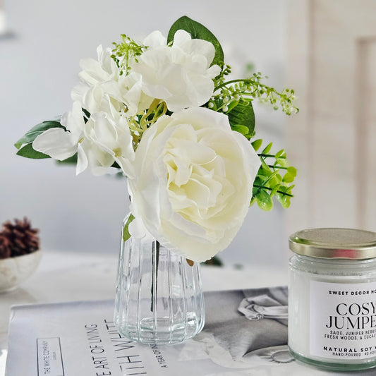 Clear glass vase with white rose flowers 