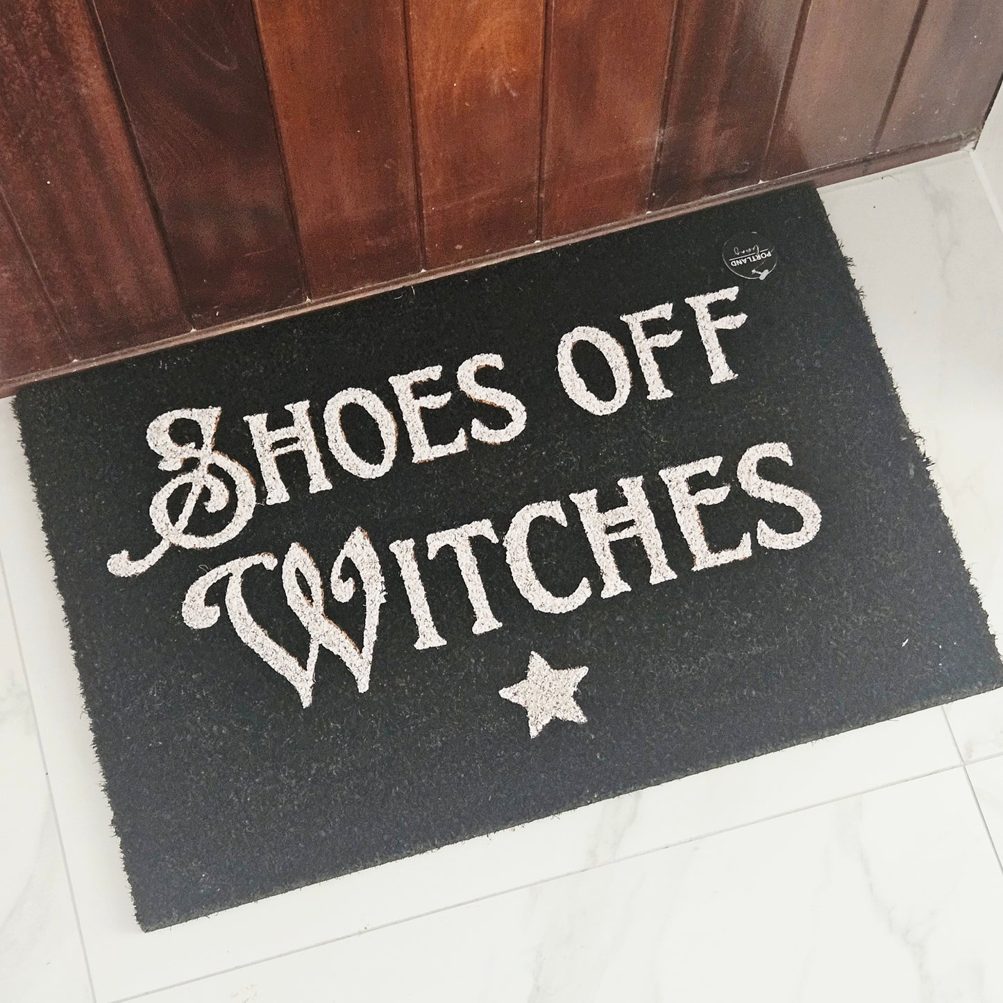 black Doormat with 'Shoes Off Witches' white text and star 40 by 60cm
