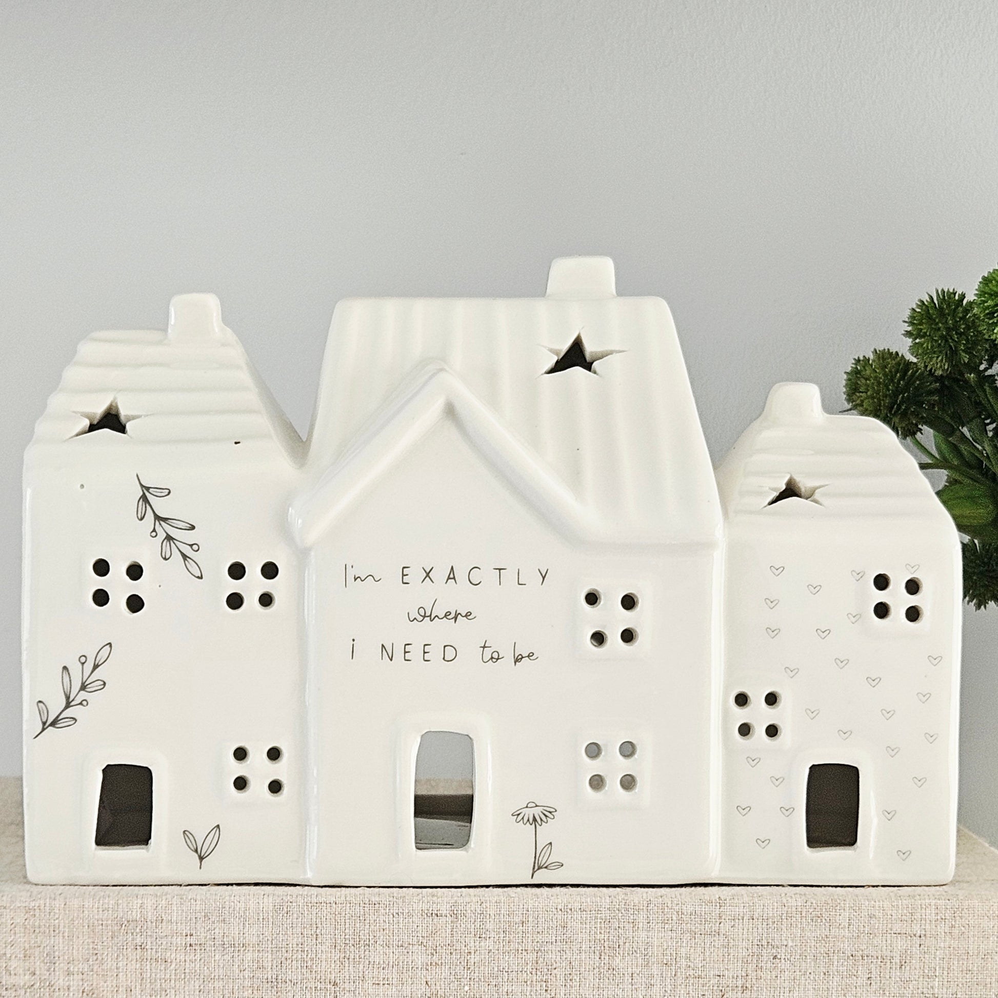 Decorative house-shaped ceramic tea light house with I'm exactly where I need to be wording and flower detail