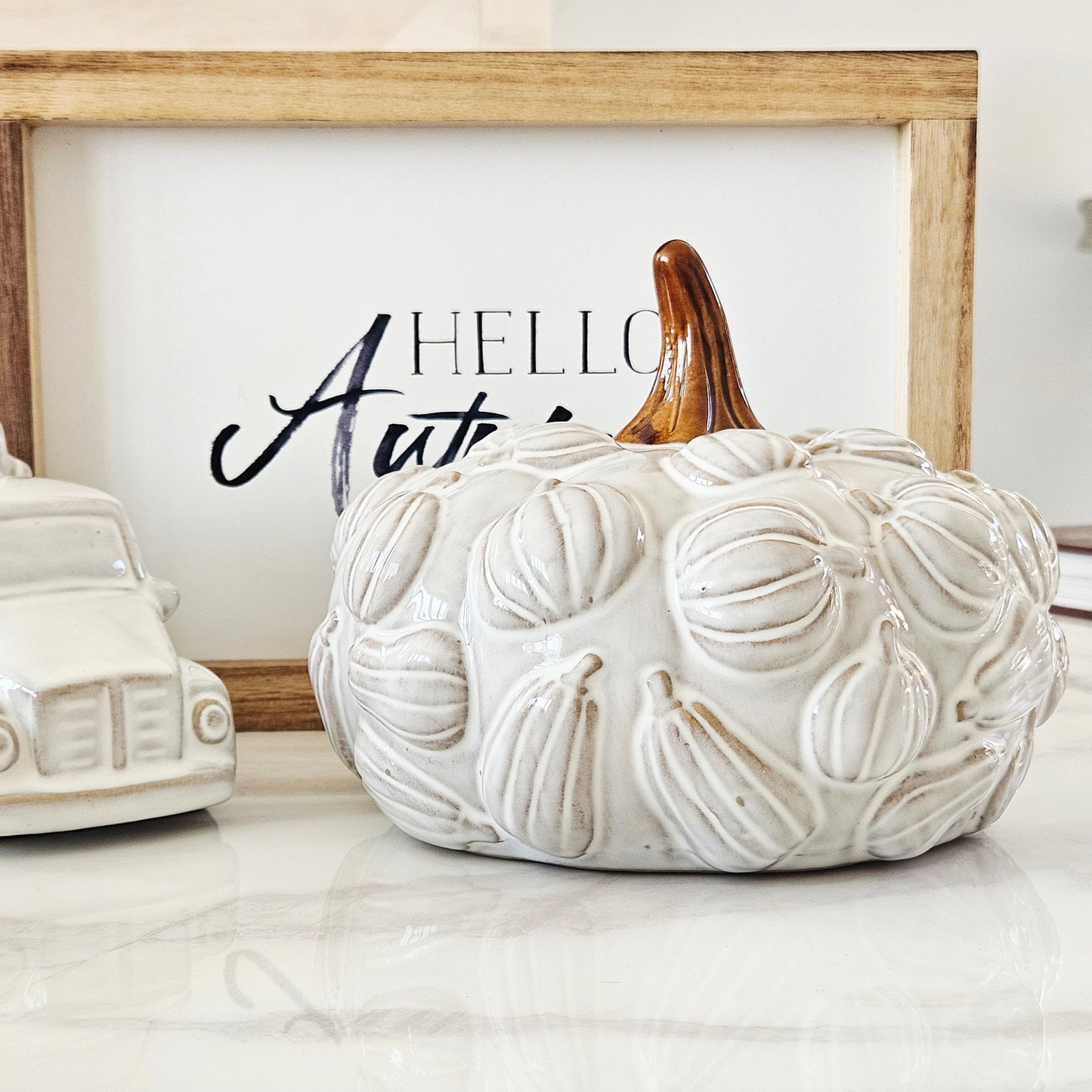 White textured ceramic pumpkin with brown stem and 3d pumpkins all over it 19cm