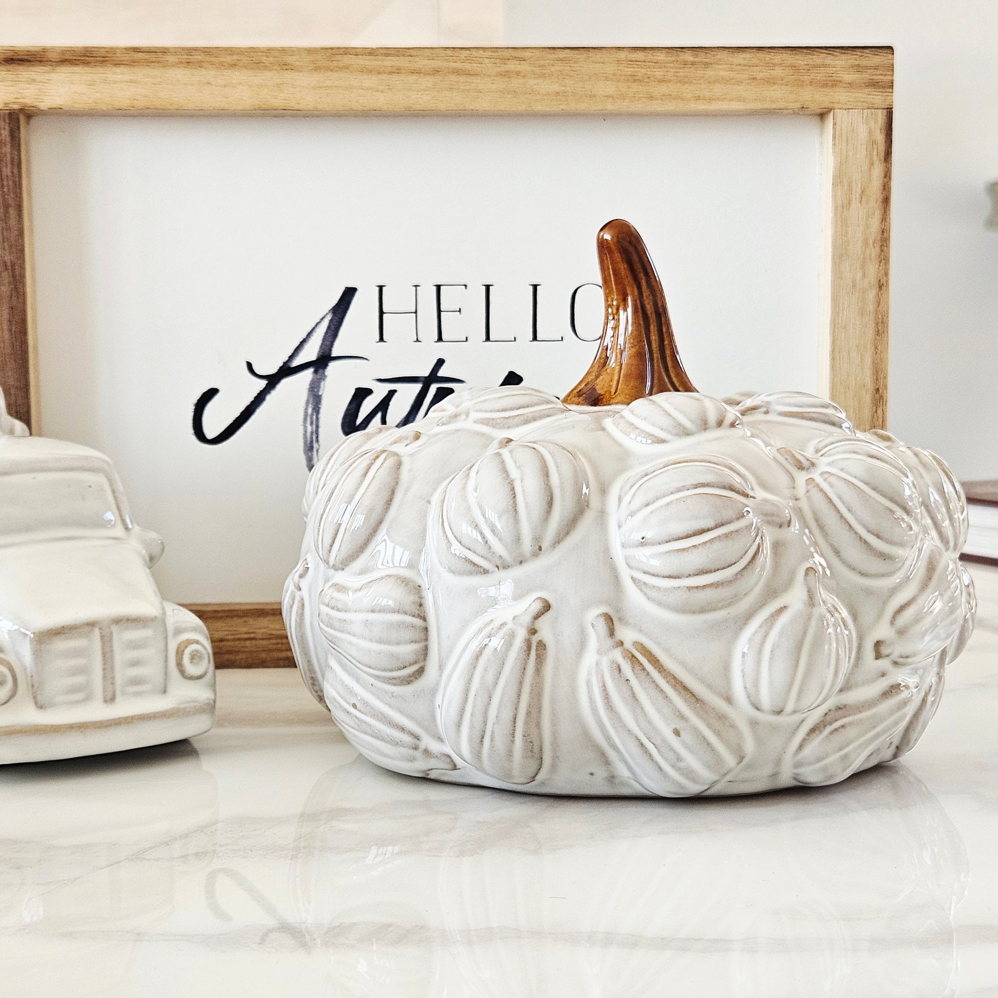 White textured ceramic pumpkin with brown stem and 3d pumpkins all over it 19cm